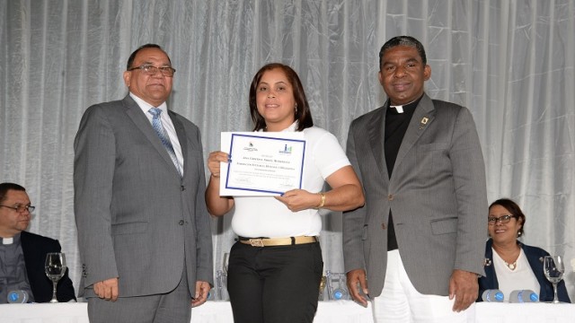 El Lic. Luis Matos y el Dr. Sergio de la Cruz entregan el certificado a la profesora Ana Cristina Abreu Rodríguez.